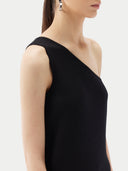 Woman wearing a black one-shoulder cashmere top against a white background #color_black