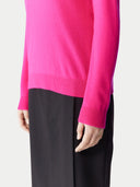 Women's Magenta Pink Cashmere Crewneck Sweater worn by model, detail view on white background 