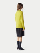 Women's Celery Yellow Cashmere Crewneck Sweater worn by model, side view on white background