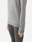 Women's Grey Cashmere Essential Crew Neck Sweater worn by model, detail view on white background