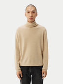 Men's Beige Cashmere Basic Turtle Neck Sweater Beige worn by model, detail view on white background
