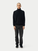 Men's Black Turtleneck Cashmere Sweater worn by model, front view on white background