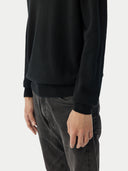Men's Black Turtleneck Cashmere Sweater worn by model, detail view on white background