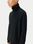 Men's Black Turtleneck Cashmere Sweater worn by model, detail view on white background