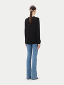 Women's Black Cashmere Crewneck Sweater worn by model, back view on white background