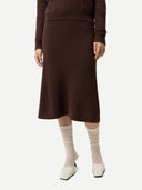 Women's Deep Mahogany  A-Line Cashmere Knitted Skirt worn by model, detail view on white background