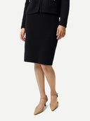 Black ribbed knit pencil cashmere skirt on a light gray background #color_black