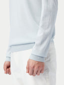 A light blue long-sleeve cashmere polo shirt with a three-button placket, displayed flat against a light gray background. #color_soft-ice
