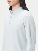 A light blue long-sleeve cashmere polo shirt with a three-button placket, displayed flat against a light gray background. #color_soft-ice