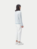 A light blue long-sleeve cashmere polo shirt with a three-button placket, displayed flat against a light gray background. #color_soft-ice