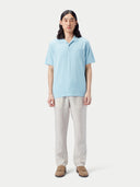 Man wearing a light blue polo shirt and white pants against a plain background #color_forget-blue