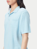 Man wearing a light blue polo shirt and white pants against a plain background #color_forget-blue
