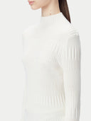 White ribbed knit cashmere sweater on a light beige background #color_pure-white