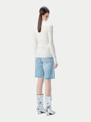 White ribbed knit cashmere sweater on a light beige background #color_pure-white