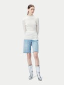 White ribbed knit cashmere sweater on a light beige background #color_pure-white