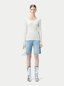 A white ribbed knit sweater with a wide boat neckline, long sleeves, and ribbed cuffs and hem, shown flat against a light gray background. #color_pure-white