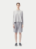 A light gray long-sleeve crewneck sweater displayed flat against a light gray background. #color_warm-light