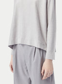 A light gray long-sleeve crewneck sweater displayed flat against a light gray background. #color_warm-light
