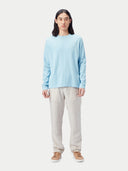A light blue long-sleeve crewneck sweater displayed flat against a light gray background. #color_forget-blue
