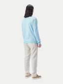 A light blue long-sleeve crewneck sweater displayed flat against a light gray background. #color_forget-blue