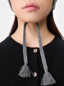 Ultimate Warmth Knit Tie Hat Dim Gray  worn by model, detail view on white background
