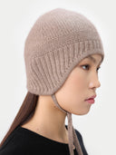  Ultimate Warmth Knit Tie Hat Taupe  worn by model, side view on white background