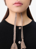 Ultimate Warmth Knit Tie Hat Taupe worn by model, detail view on white background #color_taupe