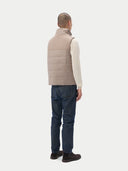 A sleeveless beige cashmere vest with a high collar, front zipper, and two large front flap pockets, shown flat against a light gray background. #color_taupe