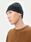 Unisex Black Cashmere Rib Knit Beanie worn by model, detail view on white background