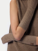 Close-up of a person wearing a ribbed knit sleeveless top with matching ribbed knit elbow-length sleeves in a taupe-brown color. A small brown label on the cuff reads GOBI .