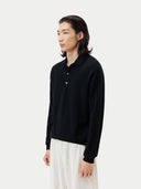 Black cashmere sweater with collar on a light gray background #color_black