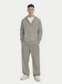 Man wearing a gray cashmere hoodie and pants set on a white background. #color_steel-silver