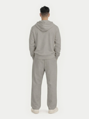 Man wearing a gray cashmere hoodie and pants set on a white background. #color_steel-silver