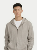 Man wearing a beige cashmere hoodie on a white background. #color_steel-silver