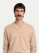 Men's Beige Cashmere V-Neck Sweater worn by model, detail view on white background