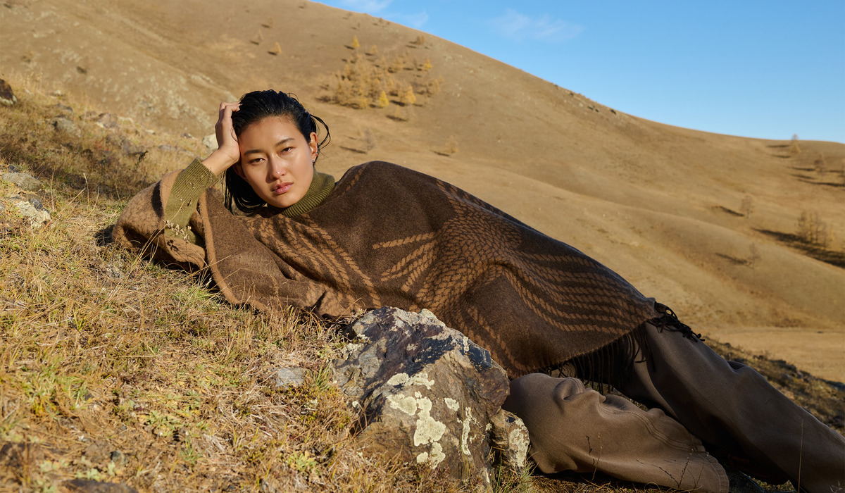 Collage of men and women wearing GOBI cashmere outdoors, with close-ups of a navy half-zip and folded sweaters