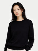 Women's Black Cashmere Crewneck Sweater worn by model, detail view on white background