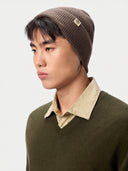 Model wearing the Seamless Cashmere Rib Knit Beanie in Brown, close front view