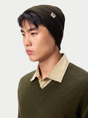 Model wearing the Seamless Cashmere Rib Knit Beanie in Olive Brown, close front view