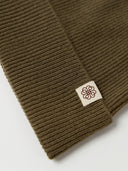 The Seamless Cashmere Rib Knit Beanie in Muted Green, close-up of the cashmere knit