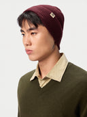 Model wearing the Seamless Cashmere Rib Knit Beanie in Wine Red, close front view