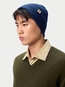 Model wearing the Seamless Cashmere Rib Knit Beanie in Deep Blue, close front view