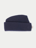 Navy blue knit beanie on a light gray background