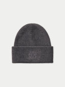 A dark gray ribbed knit beanie hat with a folded cuff and a small tonal embroidered logo on the front, shown against a light gray background.