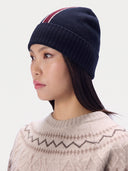 Model wearing the Cashmere Intarsia-Stripe Beanie in Navy, three-quarter side view