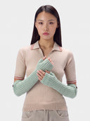 Model wearing the Cashmere Rib-Knit Fingerless Gloves in Morning green, front view
