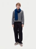 Model wearing the Fisherman Knit Scarf in Deep Blue, full-length front view