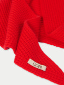 Close-up of a red garment with a 'Gobi' label on a white background