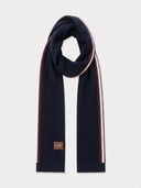 Navy cashmere knitted scarf with burgundy and cream intarsia stripes along one long edge and a GOBI leather patch, laid out flat.