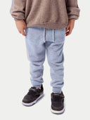 Model wearing the Kids Cashmere Track Pants in light gray, front view from the waist down